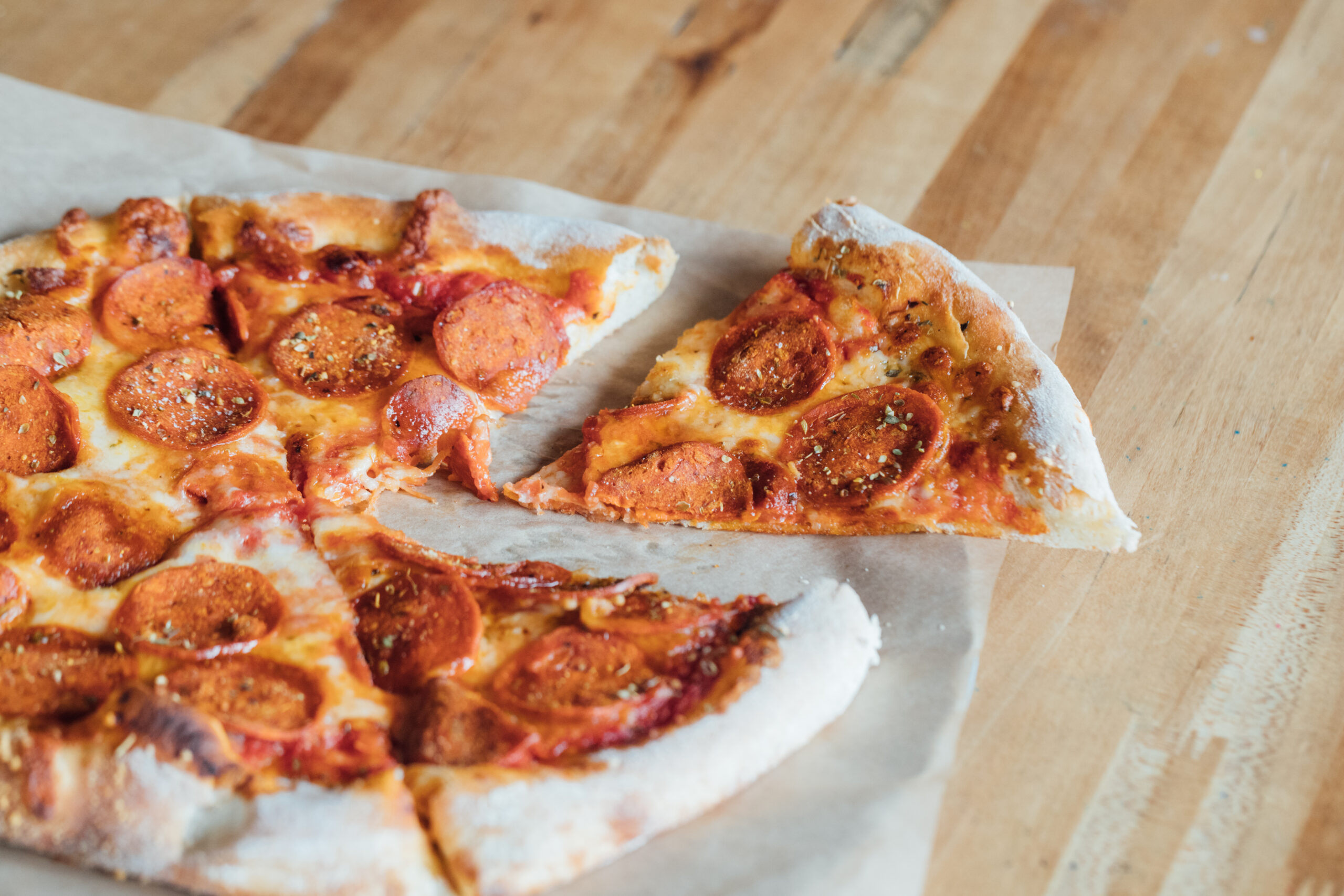 a pepperoni pizza on a table - Camps Kitchen & Bar, Marietta, GA